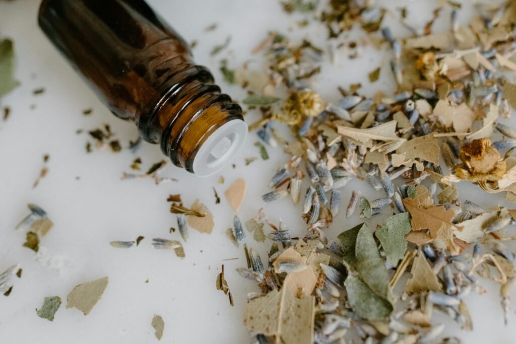 Balmy Herb Close-up of a brown glass bottle and dried herbs, ideal for aromatherapy and wellness themes.